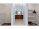 Bathroom featuring double vanity, linen closets, and tile flooring at 1910 Quiet Oak Ct, The Villages, FL 32162