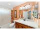 Bathroom with a vanity, a large mirror, and a tub with a shower at 1910 Quiet Oak Ct, The Villages, FL 32162