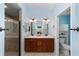 Bathroom with double sinks, a shower, and a separate toilet room at 1910 Quiet Oak Ct, The Villages, FL 32162