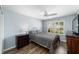 Bedroom with wood floors, white trim, neutral paint, and a bright window at 1910 Quiet Oak Ct, The Villages, FL 32162