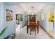 Elegant dining area with tray ceiling, hardwood flooring, and seamless access to outdoor patio at 1910 Quiet Oak Ct, The Villages, FL 32162