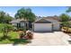 Charming home with a three-car garage and mature landscaping at 1910 Quiet Oak Ct, The Villages, FL 32162