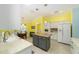 Bright kitchen featuring an island with granite countertop, white cabinets, and tile flooring at 1910 Quiet Oak Ct, The Villages, FL 32162