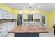 Open kitchen with granite countertops, stainless steel appliances, and tile backsplash at 1910 Quiet Oak Ct, The Villages, FL 32162