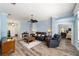 Cozy living room with neutral paint, ceiling fan, stylish furnishings, and an open doorway to bedroom at 1910 Quiet Oak Ct, The Villages, FL 32162