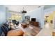 Spacious living room featuring an open layout, neutral walls, and hardwood flooring at 1910 Quiet Oak Ct, The Villages, FL 32162