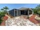 Relaxing outdoor space with screened enclosure and brick paver patio, perfect for enjoying the outdoors at 1910 Quiet Oak Ct, The Villages, FL 32162