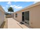 Home exterior featuring a private patio, landscaping, and access to the interior through a sliding glass door at 1963 Ladyfish Ave, The Villages, FL 32162