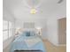 Bright bedroom features a ceiling fan, plantation shutters, and coastal-themed decor at 1963 Ladyfish Ave, The Villages, FL 32162