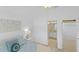 Bright bedroom featuring ensuite bathroom, walk-in closet, soft blue bedding, and modern decor at 1963 Ladyfish Ave, The Villages, FL 32162