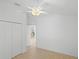 Bright bedroom with ceiling fan, closet, and neutral flooring at 1963 Ladyfish Ave, The Villages, FL 32162