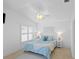Comfortable bedroom boasts a ceiling fan, plantation shutters, and soft, serene blue accents at 1963 Ladyfish Ave, The Villages, FL 32162