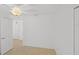 Bare bedroom with ceiling fan, neutral floor, and a hallway leading to an adjacent room at 1963 Ladyfish Ave, The Villages, FL 32162
