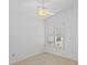 Neutral bedroom with ceiling fan and a window letting in natural light at 1963 Ladyfish Ave, The Villages, FL 32162
