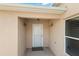 Covered entryway with decorative wall sconces at 1963 Ladyfish Ave, The Villages, FL 32162