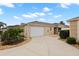 Charming one-story home featuring a two-car garage and a well-maintained front yard at 1963 Ladyfish Ave, The Villages, FL 32162