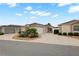 Charming single story home with well maintained landscaping and a long driveway under a cloudy blue sky at 1963 Ladyfish Ave, The Villages, FL 32162