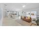 Open-concept living room showcasing tile floors, recessed lighting, and seamless flow to the kitchen and dining areas at 1963 Ladyfish Ave, The Villages, FL 32162