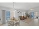 Open-concept living area with natural light, a dining table, and access to outdoor spaces at 1963 Ladyfish Ave, The Villages, FL 32162