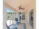 Enclosed sunroom with ceiling fan, tile flooring and sliding doors that lead to outdoor patio at 1963 Ladyfish Ave, The Villages, FL 32162