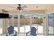 Relaxing sunroom with large sliding doors showcasing the backyard patio and landscaping at 1963 Ladyfish Ave, The Villages, FL 32162