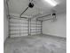 Spacious two-car garage with white doors and a concrete floor at 2025 Axel St, Minneola, FL 34715