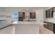 Modern kitchen with stainless appliances, quartz countertops, gray cabinets and a large island at 2025 Axel St, Minneola, FL 34715