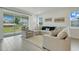 Bright living room with large sliding glass doors offering backyard views and comfortable seating at 2025 Axel St, Minneola, FL 34715