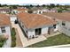 Aerial view of the property showcasing the patio, landscaping, and surrounding neighborhood at 2050 Duval Ct, The Villages, FL 32162