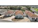 Aerial view of a well-maintained home with a brown roof, green shutters, and a landscaped yard in a residential neighborhood at 2050 Duval Ct, The Villages, FL 32162