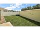 Well-maintained backyard with green lawn, privacy fence, and decorative turtle accents at 2050 Duval Ct, The Villages, FL 32162