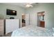 Well-lit bedroom featuring a mounted TV and an ensuite bathroom for added convenience at 2050 Duval Ct, The Villages, FL 32162