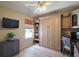 Bright bedroom featuring a murphy bed, built-in shelves, a computer desk, and a window at 2050 Duval Ct, The Villages, FL 32162
