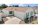 Charming single-story home featuring white siding, a brown roof, green shutters, and a well-manicured lawn at 2050 Duval Ct, The Villages, FL 32162