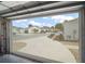 View from inside the garage looking out onto the charming residential street at 2050 Duval Ct, The Villages, FL 32162