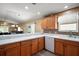 Bright, modern kitchen with white countertops, wood cabinets, mosaic tile backsplash, and stainless steel appliances at 2050 Duval Ct, The Villages, FL 32162