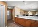 Modern kitchen with wood cabinets, white countertops, stainless steel appliances, and an open view to the living room at 2050 Duval Ct, The Villages, FL 32162