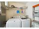 Functional laundry room with modern washer and dryer set, plus ample storage shelves at 2050 Duval Ct, The Villages, FL 32162