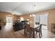 Open-concept living and dining area with wood floors, sliding glass doors, and comfortable seating at 2050 Duval Ct, The Villages, FL 32162