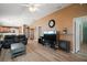 Cozy living room with wood floors, comfortable seating, a ceiling fan, and an open layout to the kitchen at 2050 Duval Ct, The Villages, FL 32162