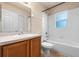 Bright bathroom featuring a single sink vanity, tub, and tiled walls at 211 Highland Meadows Ct, Davenport, FL 33837