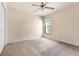 Bedroom with carpet, ceiling fan and backyard view through the window at 211 Highland Meadows Ct, Davenport, FL 33837