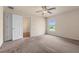 Spacious bedroom with neutral carpet, ceiling fan, and a sunny window at 211 Highland Meadows Ct, Davenport, FL 33837