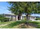 Charming single-story home with mature trees and landscaping. Two car garage and inviting front entrance at 211 Highland Meadows Ct, Davenport, FL 33837