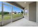 Screened lanai showcasing backyard views, with stucco walls and concrete flooring at 211 Highland Meadows Ct, Davenport, FL 33837