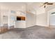 Open-concept living room showcasing neutral walls, plush carpeting, and easy access to the kitchen area at 211 Highland Meadows Ct, Davenport, FL 33837