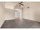 Bright living room featuring neutral walls, plush carpeting, ceiling fan, and an arched entrance at 211 Highland Meadows Ct, Davenport, FL 33837