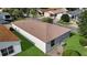 Aerial view of the home's roof, siding and backyard with well-maintained lawn at 2111 Thornton Ter, The Villages, FL 32162
