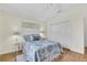 Cozy bedroom featuring wood floors, closet, and stylish nautical themed decorations at 2111 Thornton Ter, The Villages, FL 32162