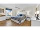 Well-lit bedroom with wood flooring and a decorative comforter set at 2111 Thornton Ter, The Villages, FL 32162